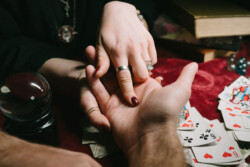 reading the lines hand in a man's hands, close view Tarot Card Reading